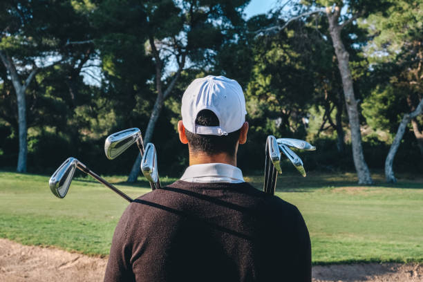 istock Rear view of a golf player with several golf sticks resting on the shoulder 1154425055