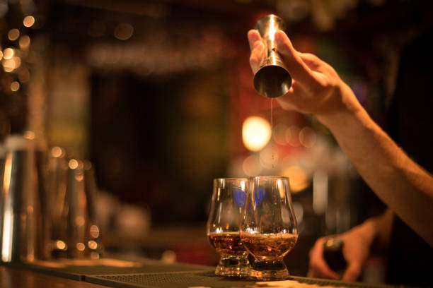 istock Bartender pouring whisky in a glass 1154425246
