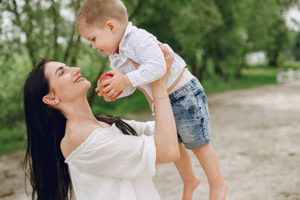 istock Mother with son playing in a summer park 1154426972