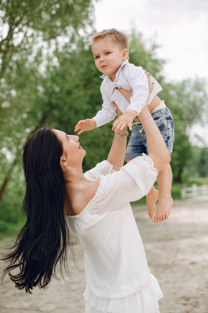 istock Mother with son playing in a summer park 1154426991