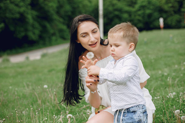 istock Mother with son playing in a summer park 1154427749