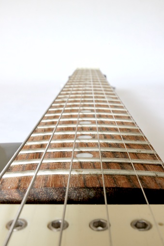 The fretboard of an electric guitar.