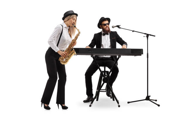 istock Young woman playing a sax and a man playing keyboards 1154429119
