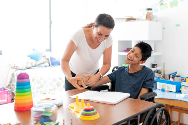 istock Mother playing with son with Cerebral Palsy 1154429335