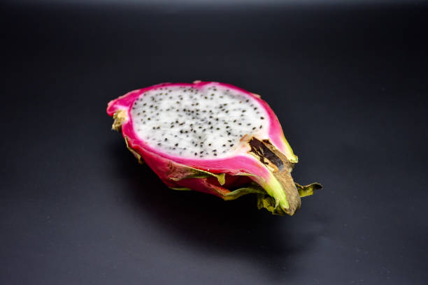 istock cut pitahaya on black background close up, cut dragon fruit 1154431867