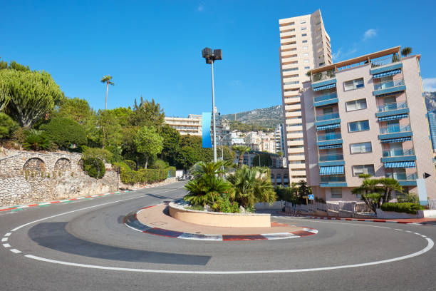 Monte Carlo street curve with open-wheel single-seater racing car red and white signs in a sunny summer day in Monte Carlo, Monaco Monte Carlo street curve with open-wheel single-seater racing car red and white signs in a sunny summer day in Monte Carlo, Monaco monte carlo stock pictures, royalty-free photos & images