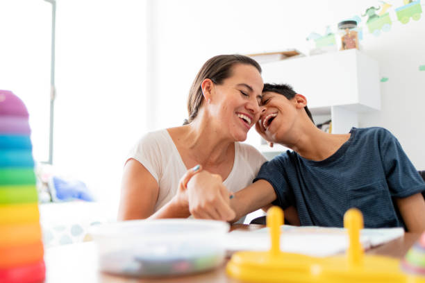 istock Mother playing with son with Cerebral Palsy 1154434462