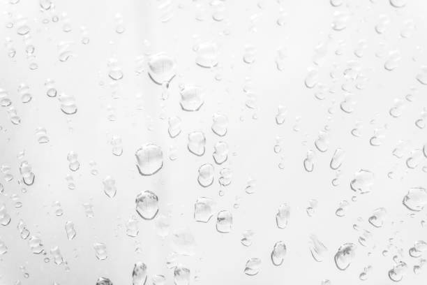 istock Water drops on glass white gray background. 1154435712