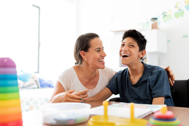 Mother playing with son with Cerebral Palsy