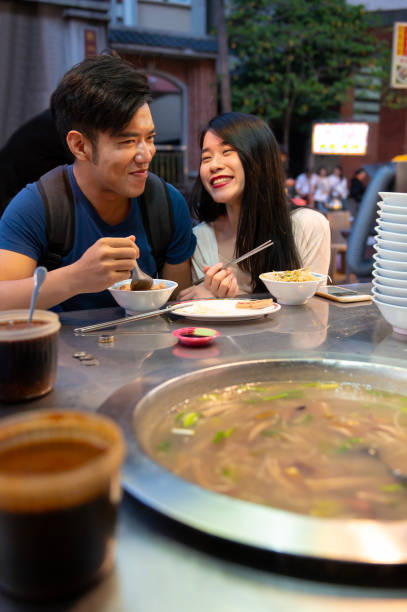 istock Cheerful couple enjoying a night market 1154436839