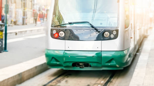 modern public tram seen from the front. modern public tram seen from the front. public transport. Urban transport by rail blurred motion street car green stock pictures, royalty-free photos & images