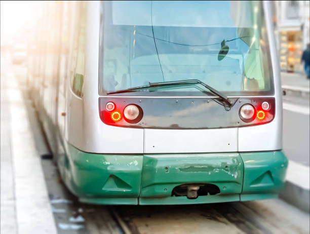 modern public tram seen from the front. modern public tram seen from the front. public transport. Urban transport by rail blurred motion street car green stock pictures, royalty-free photos & images