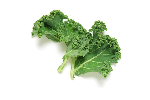 Piece of fresh Kale on white background, shot from above