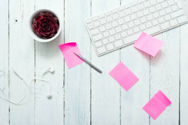 Place of work with pink post its work place with pink post its and succulent plant, top view white shabby chic desk stock pictures, royalty-free photos & images