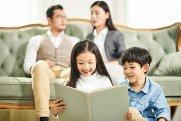 istock asian children reading book at home 1154444364
