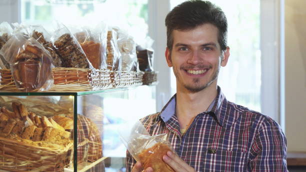 istock Attractive young man buying cookies at the bakery 1154445149
