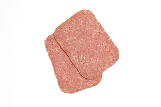 istock Two slices of corned beef isolated on white background 1154447815