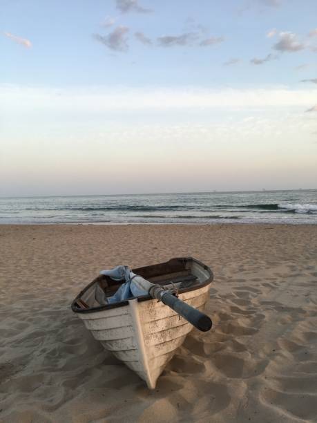 istock Rowboat on the sand at sunsets 1154448095