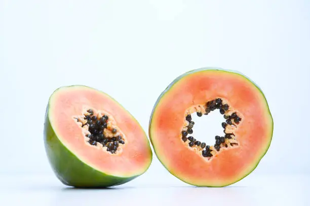 Slices of papaya on white background