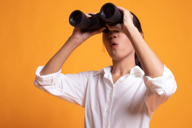 istock Young Asian woman with binoculars. 1154449367
