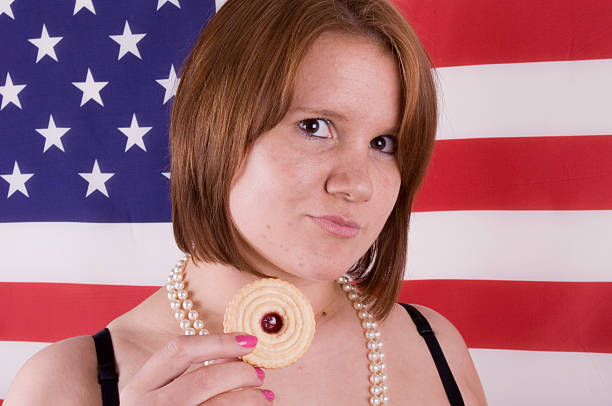 istock Redhead model with biscuit against american flag 115444990