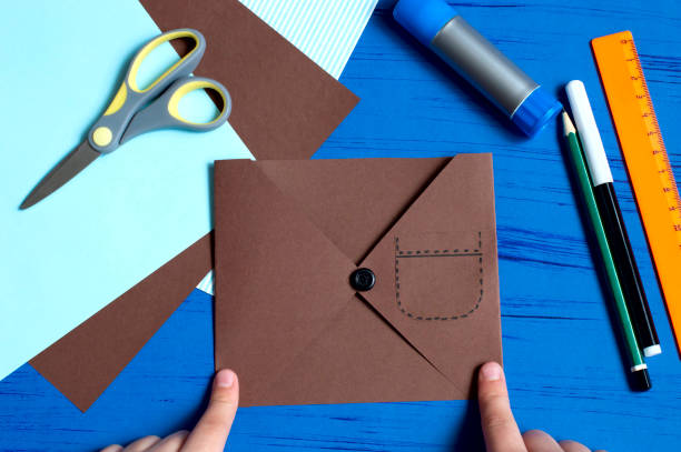 istock Child makes greeting card for Father's Day. Step 7 1154451722
