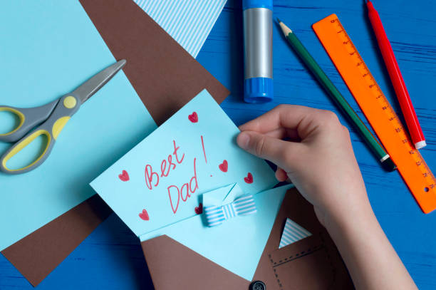 istock Child makes greeting card for Father's Day. Step 12 1154451730