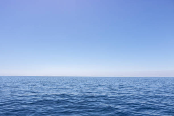 istock Seascape with sea horizon and almost clear deep blue sky 1154453096