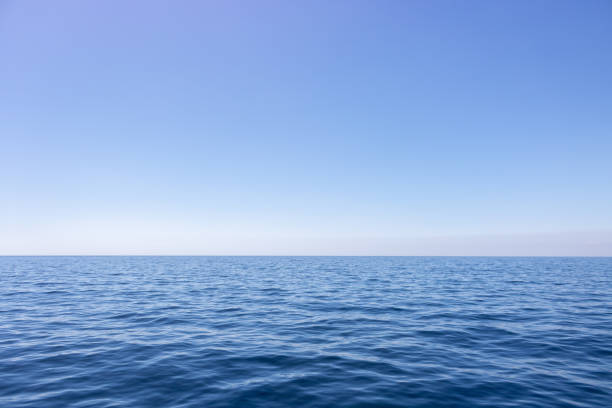 Seascape with sea horizon and almost clear deep blue sky