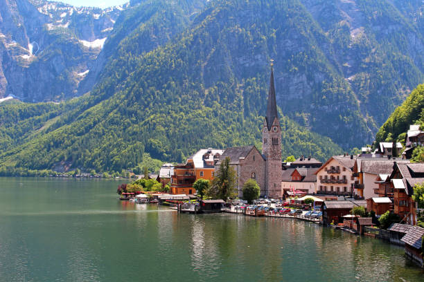 Famous Austria village Hallstatt with church and lake stock photo