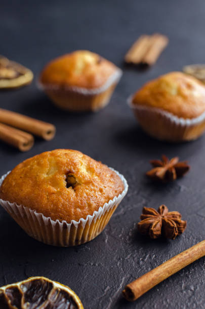 istock Sweet muffins with on dark textured background. 1154461288