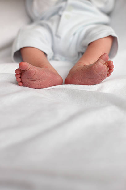 istock Newborn Baby Boy Feet 115446702