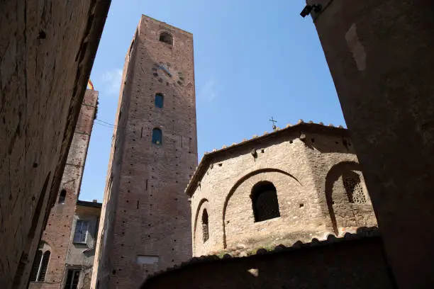 Baptistry and civic tower, sunny day, Albenga, Liguria, Italy.
