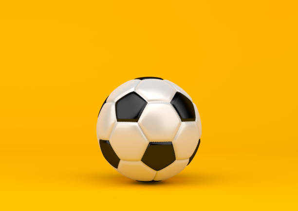 istock Soccer ball on pastel yellow background 1154472987