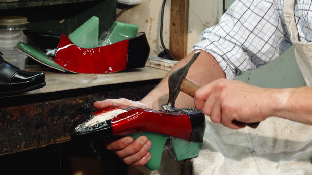 istock Professional shoemaker making new shoes at his workshop 1154474645