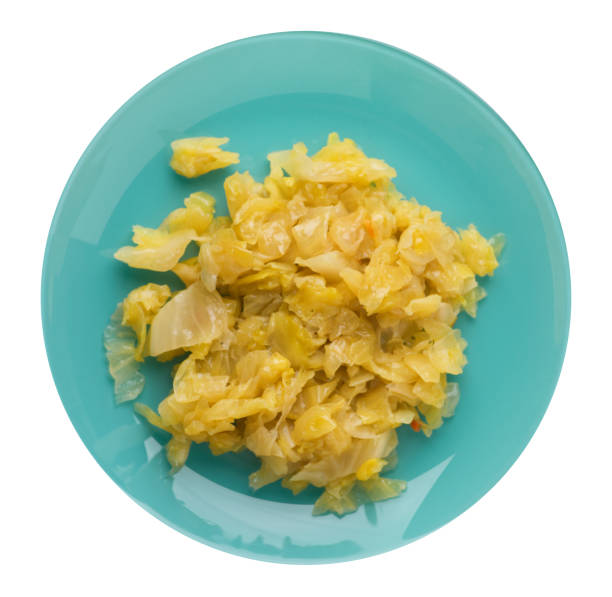 istock braised cabbage in plate isolated on white background.  cabbage top view 1154476781