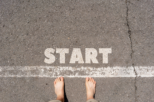 view from above of a person on the start line with text word design