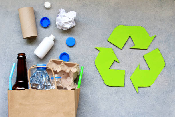 istock Recycling symbol and different garbage on gray background. Top view. 1154483166