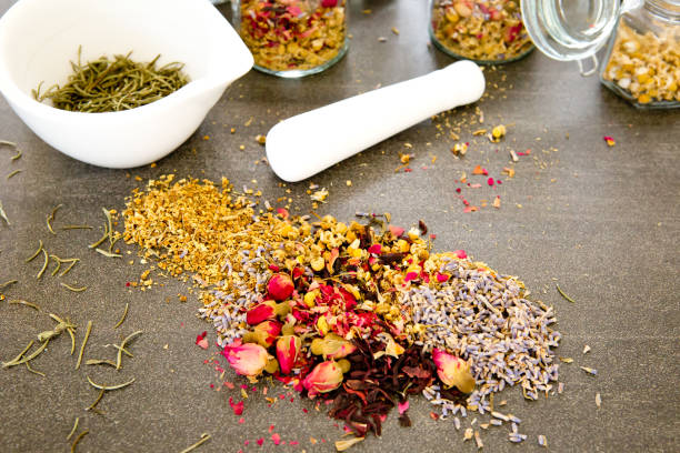 istock Dried mixed Herbs on gray / grey slate background with mortar and pestle 1154484973