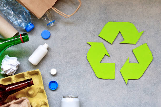 istock Recycling symbol and different garbage on gray background. Top view. 1154485040
