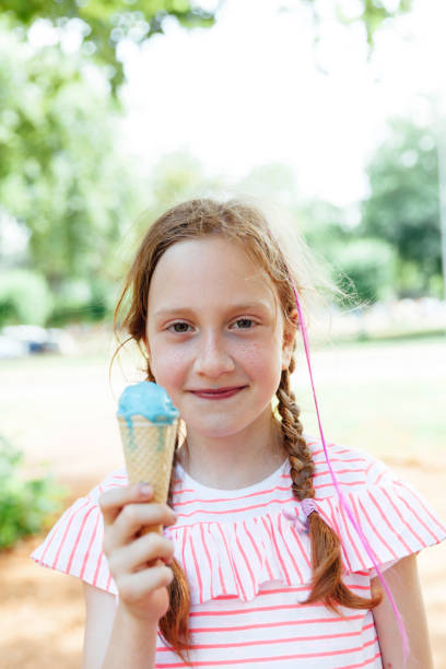 istock Beautiful child holding ice cream 1154486087
