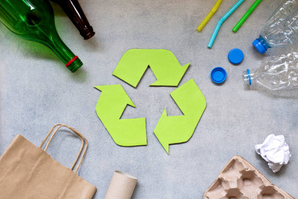 istock Recycling symbol and different garbage on gray background. Top view. 1154489398
