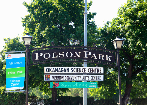 Vernon,British Columbia, Canada- May 27,2019: Signage for various activities and venues in Polson Park. Large trees in background