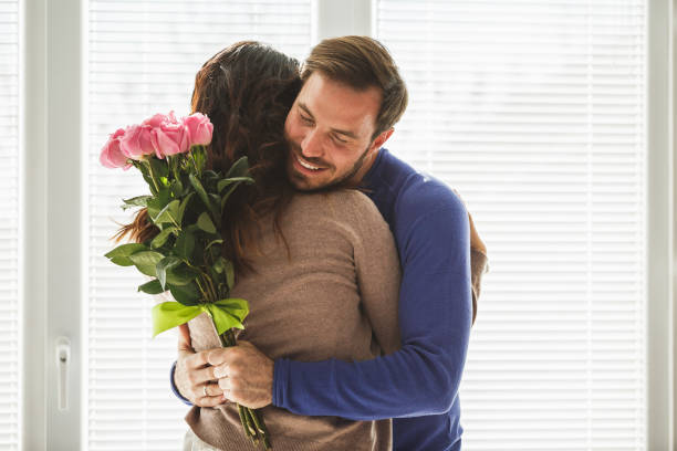 istock Man giving roses to his wife 1154490923