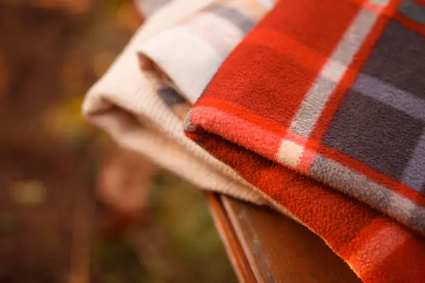 Photo of Warm blankets on a bench outdoors