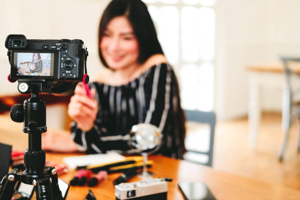 istock beauty blogger live broadcasting cosmetic makeup tutorial on social media. 1154492082