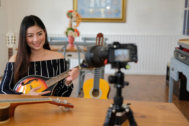 istock blogger live broadcasting music instrument tutorial on social media. vlogger recording online vlog video. 1154492092
