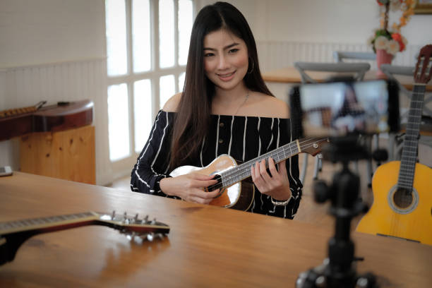 istock blogger live broadcasting music instrument tutorial on social media. vlogger recording online vlog video. 1154492093