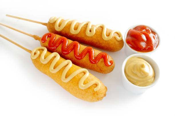 istock Corn dogs with ketchup and mustard on white background 1154501014