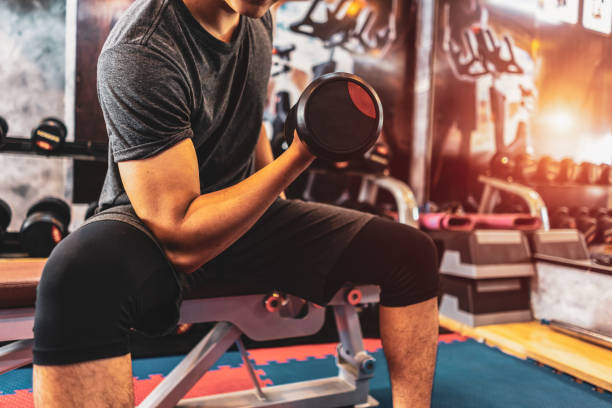 istock Attractive young ripped bodybuilder working out in gym. 1154502414